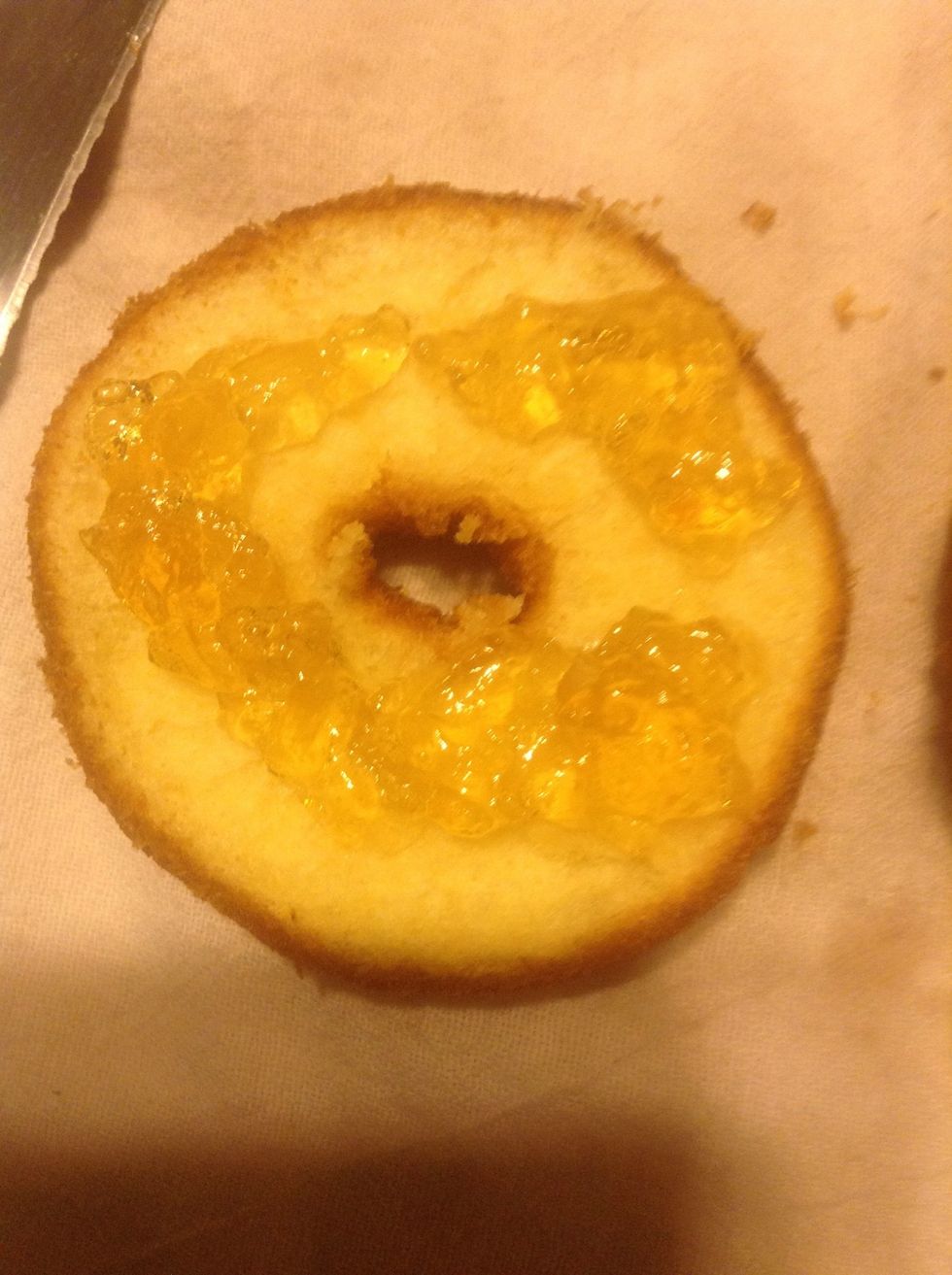 Pipe your filling on the bottom half. Don't over fill! Do this for all 12. Place the tops back on and place on the cooling rack to be glazed!