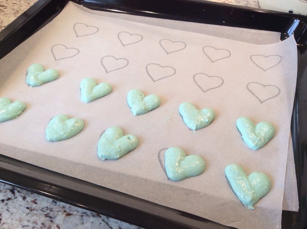 Pipe your mixture in heart shapes on a baking tray lined with baking paper (you can pipe a few circles if you have extra mixture) to make it easier you can use a heart template (10-15 minutes)