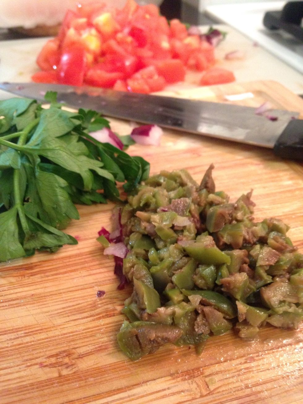Pit and chop the olives