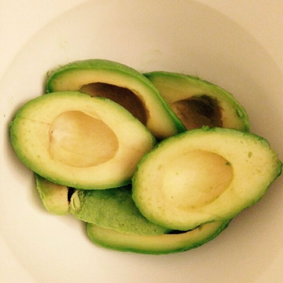Pit and peel the avocados and place them in a bowl