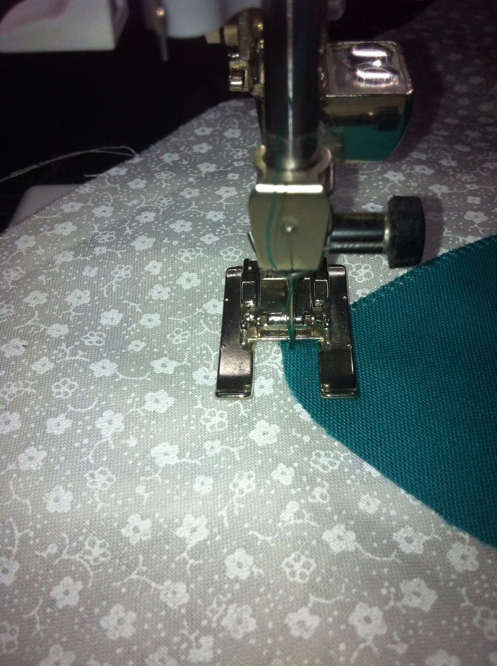 Pivot with needle in the background and keep on stitching around the curve.