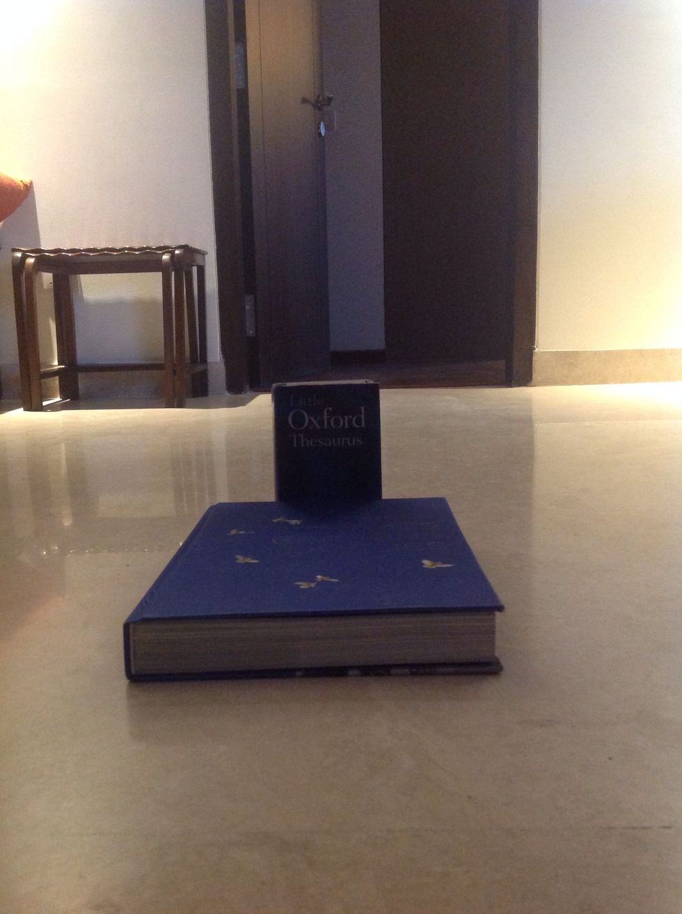 Place 1 thick book and 1 small strong book as shown.