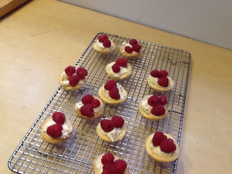 Place 2-3 raspberries on each pastry.