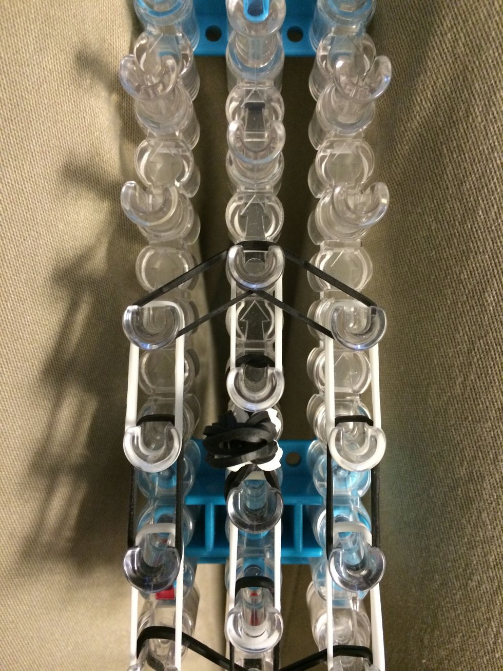 Place 2 black bands from the left to the center and from the right to the center. Let's go ahead and put on the ears before we move to the body