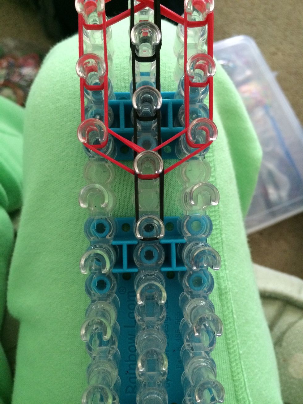 Place 2 black rubber bands down the middle