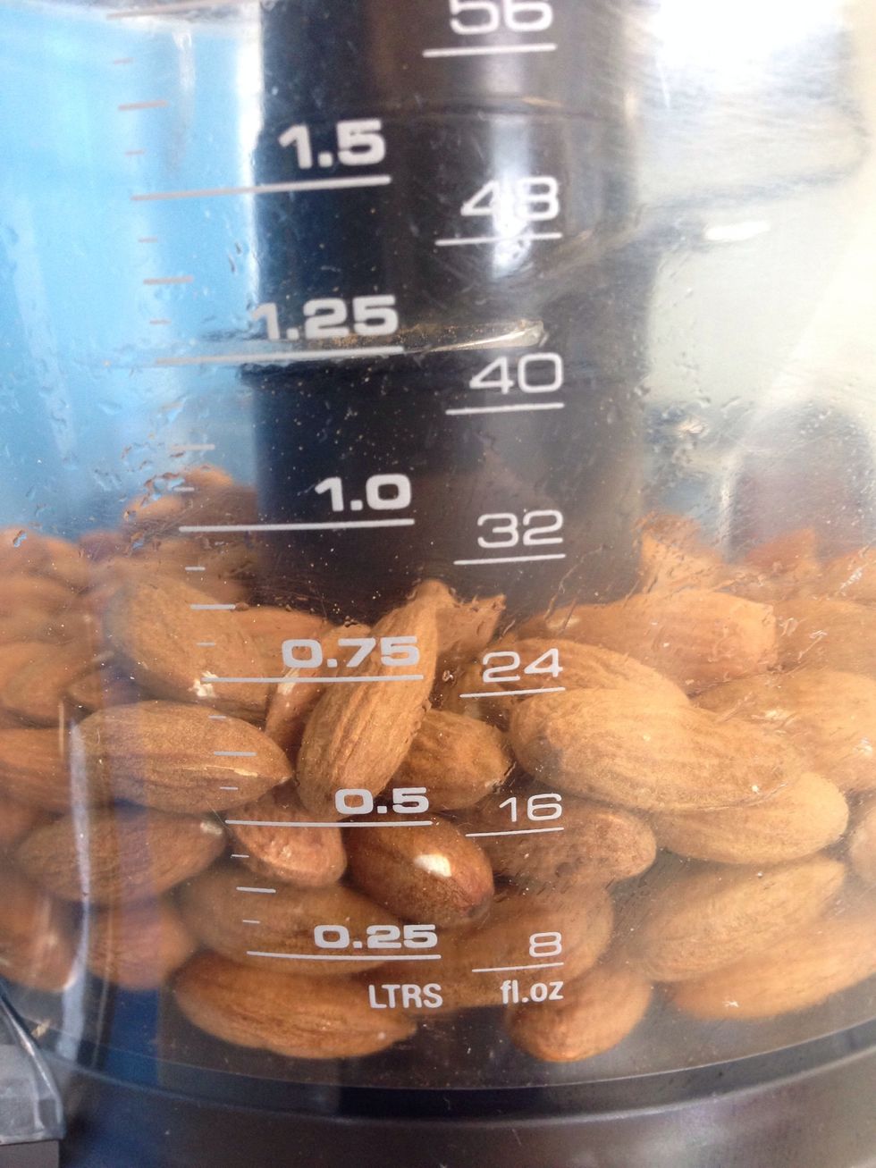 Place 2 cups of raw almonds into the food processor and blitz until the almonds are broken up roughly.
