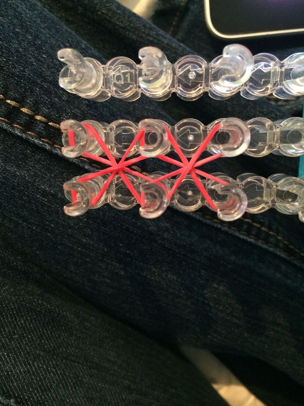 Place 2 more bands going the opposite way. Make sure you twist them. Push down the rubber bands.