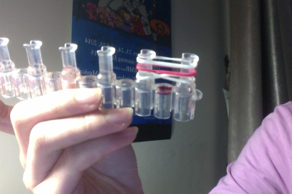 Place 2 more rubber bands on top of the '8' rubber band. Before you do anything, make sure there is always 3 rubber bands on the 2 pegs.