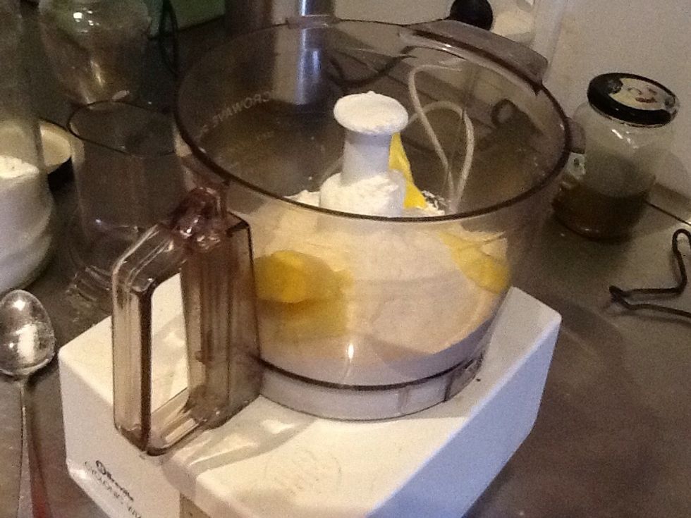 Place 2 table spoons of caster sugar, 1 cup of plain flour and 100 grams of unsalted butter in a food processor and process.