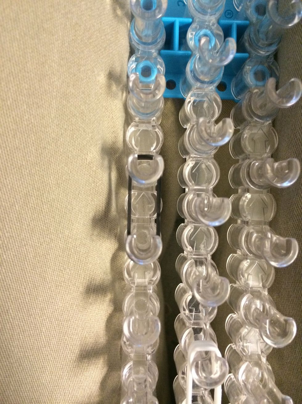 Place 3 black bands some where on your loom. This is going to be the nose.