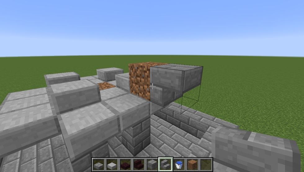 Place 3 Stone Slabs at the top of each Stone Brick block. Then place a dirt block down and an upside down stair.