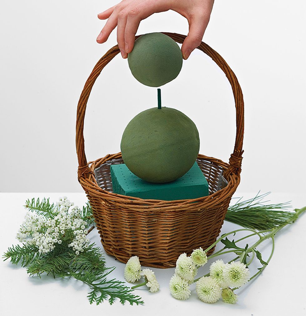 Place 4\u201d oasis sphere on oasis block then place 3\u201d oasis sphere on top and secure with floral pick.