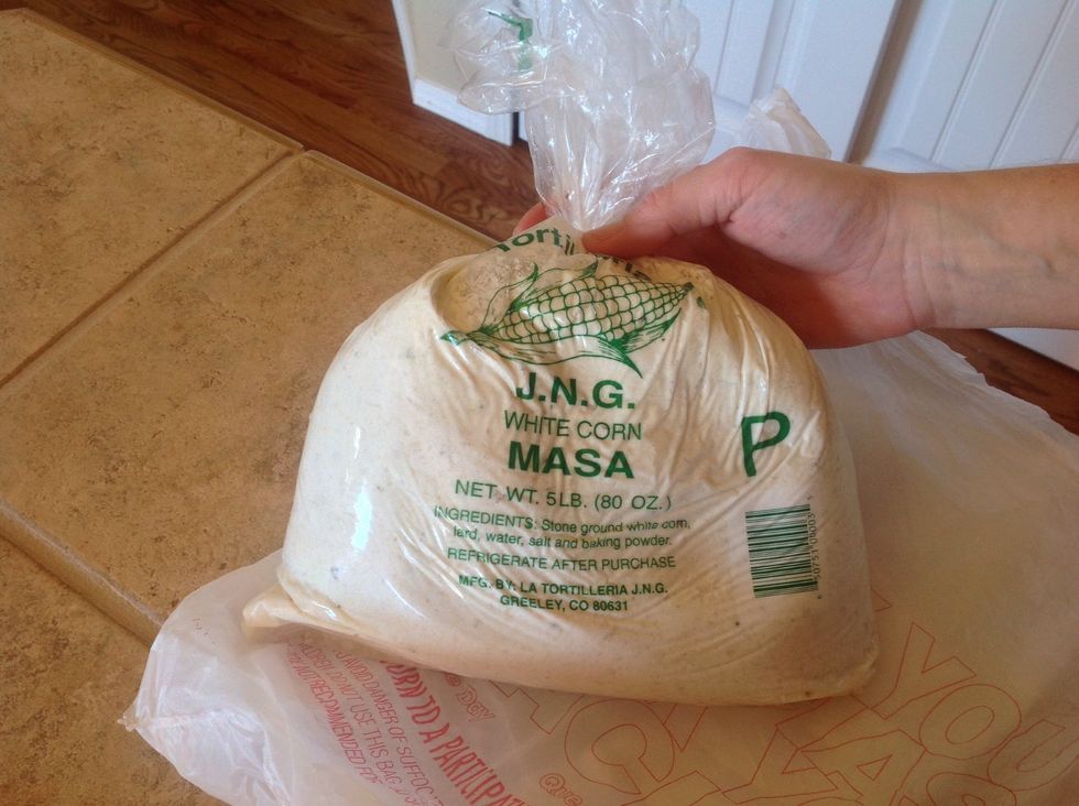 Place 5 lbs white corn masa mix into large bowl.