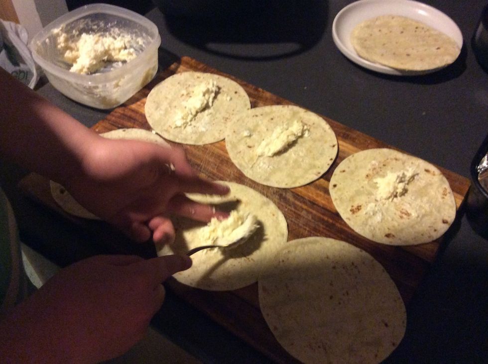 Place 6 tortilla wraps out and place some ricotta mixture on each.