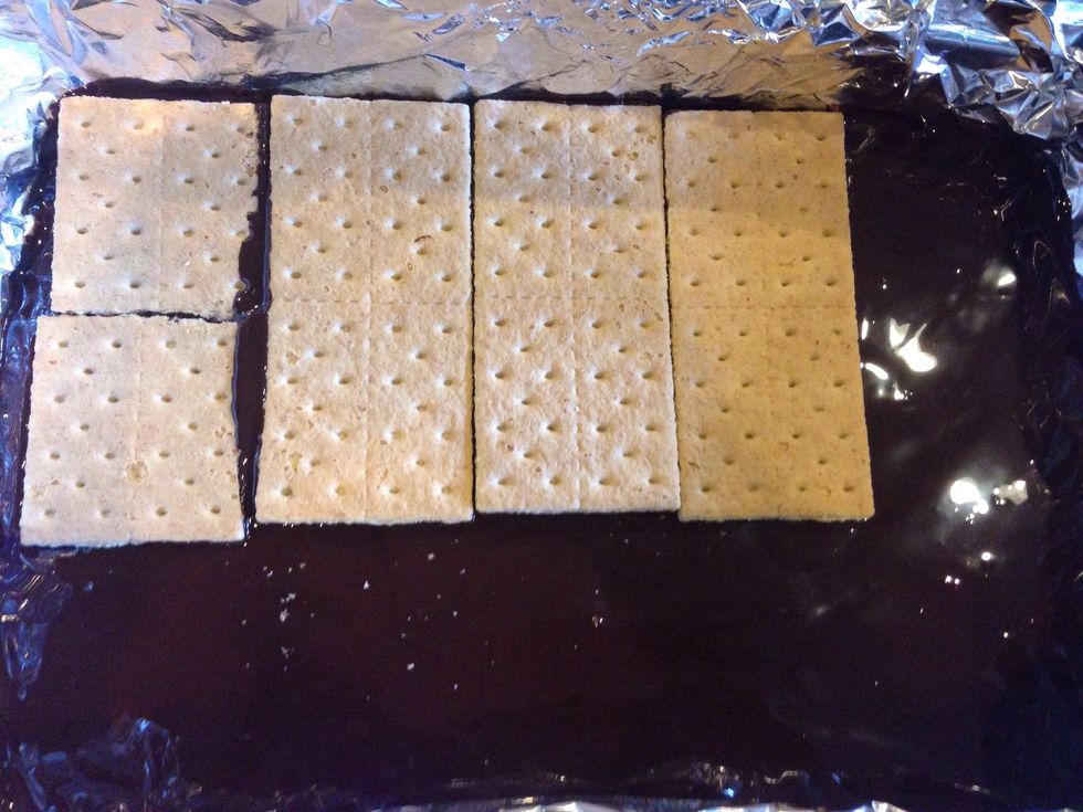 Place 8 full graham cracker sheets across chocolate layer.
