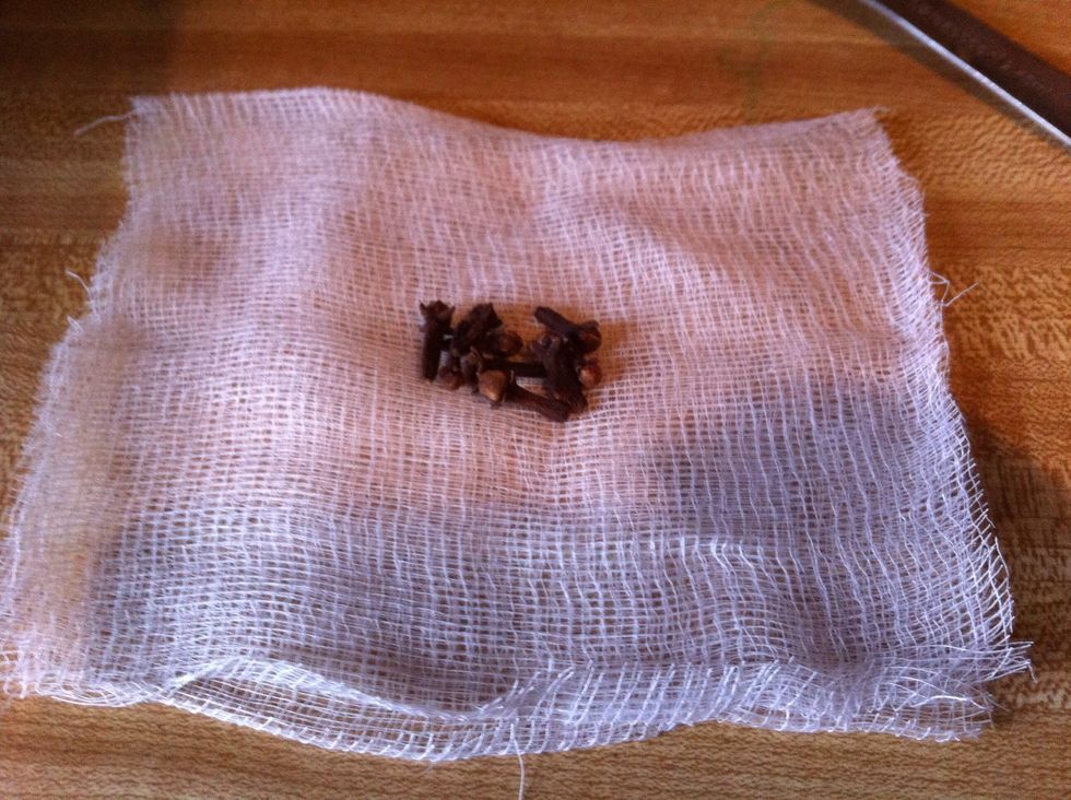 Place 9 whole cloves in the center of cheese cloth
