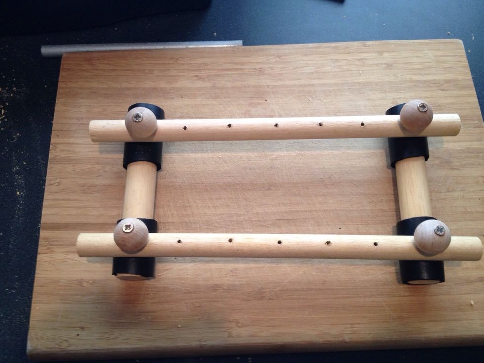 Place a ball knob in this fashion in each place where the dowel rods meet. Use longer screws for this. This gives it stability.