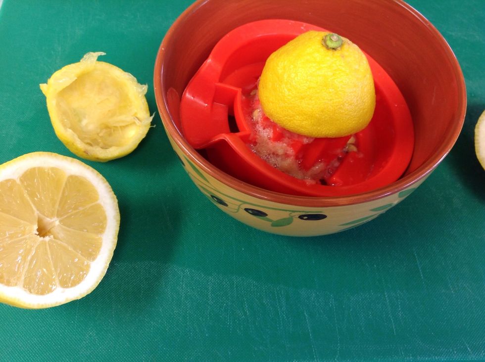Place a bowl underneath juicer to catch the juice from the lemons