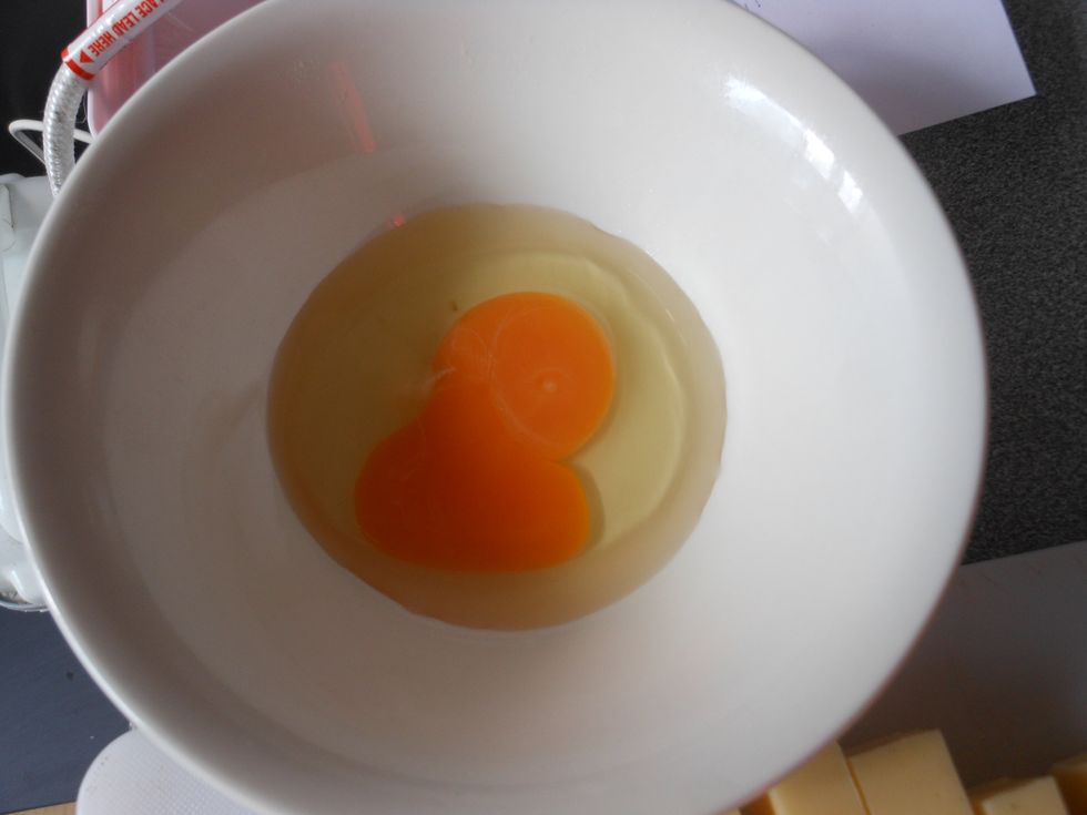 Place a egg in a bowl.