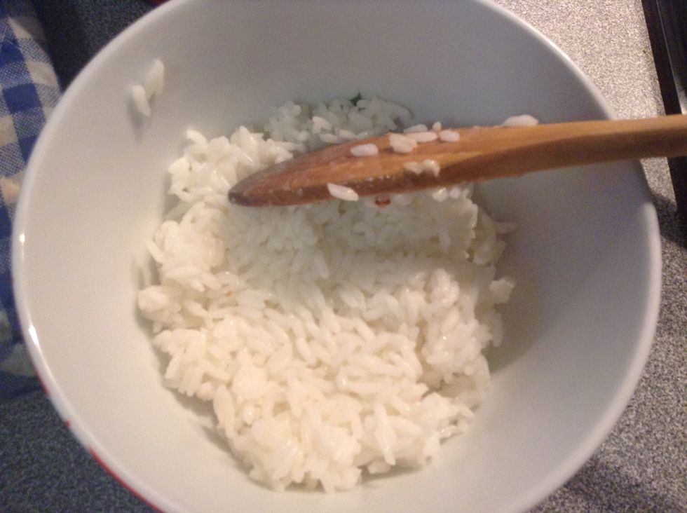 Place a few spoonfuls of rice in the bottom of a bowl, and press down with the spoon. Continue to add the rest of the rice until the bowl is full.