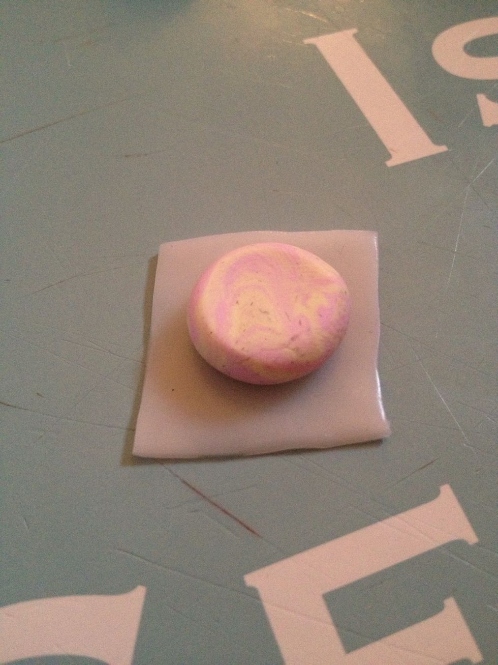 Place a flattened disc on top of one of the translucent squares.