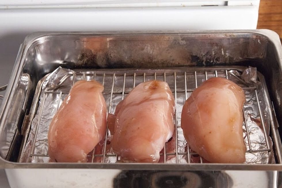 Place a foil lined tray onto to the wood chips. Lay the chicken on the tray.Close the lid of the smoker except for a tiny bit left open.
