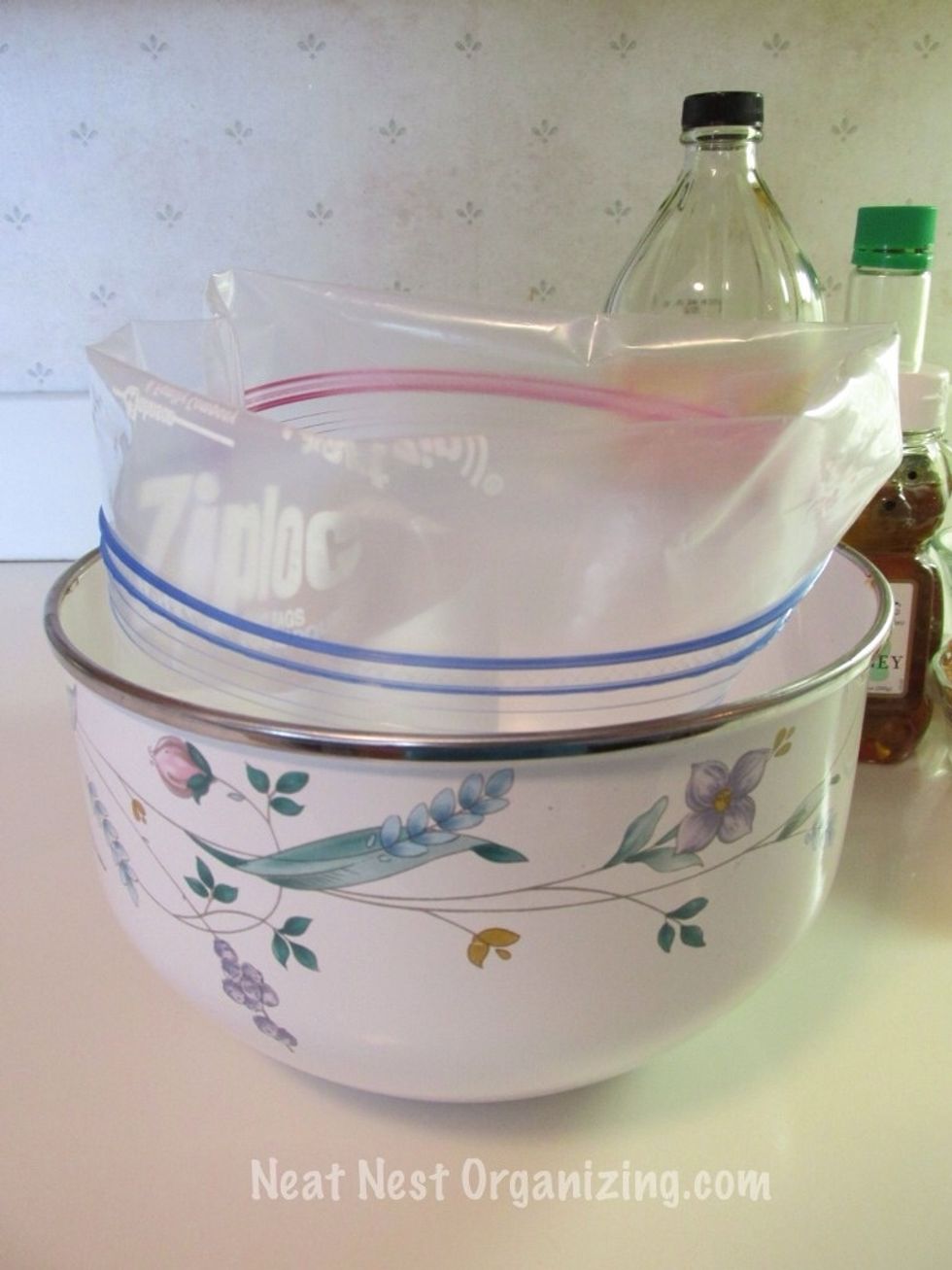 Place a gallon-sized freezer bag in a bowl. Fold the top of the bag down.