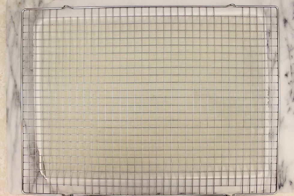 Place a large cooling rack on top of parchment paper. Hold everything together and FLIP.