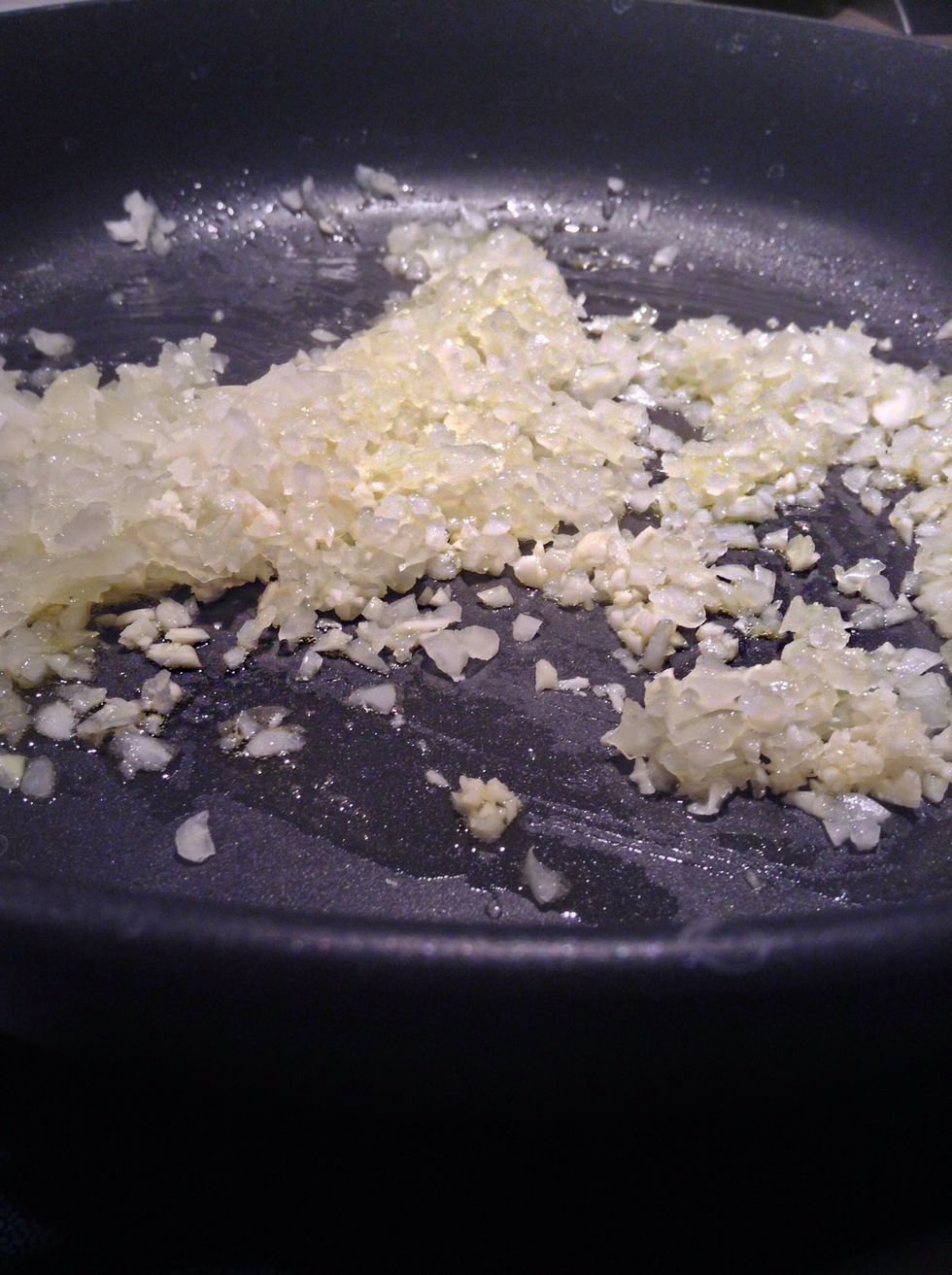 Place a medium size sauce pan over medium heat, add in onions, garlic and olive oil cook until onions become clear.