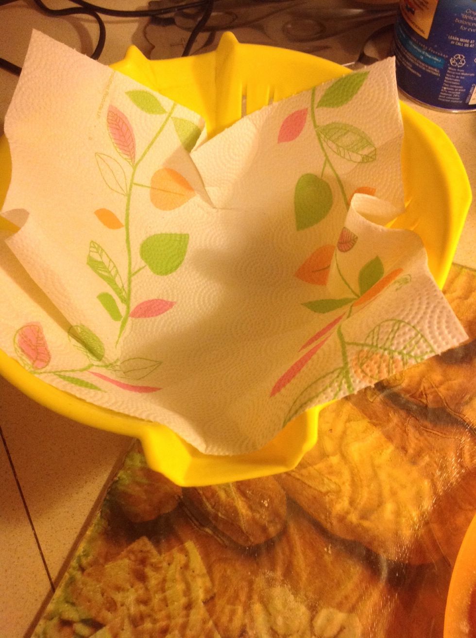 Place a napkin in the strainer a minute before chicken is ready, the napkin helps keep the oil from leaking everywhere