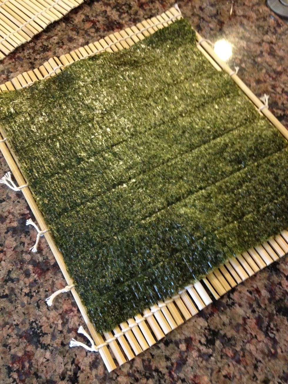 Place a nori sheet onto the bamboo mat, shiny face down.