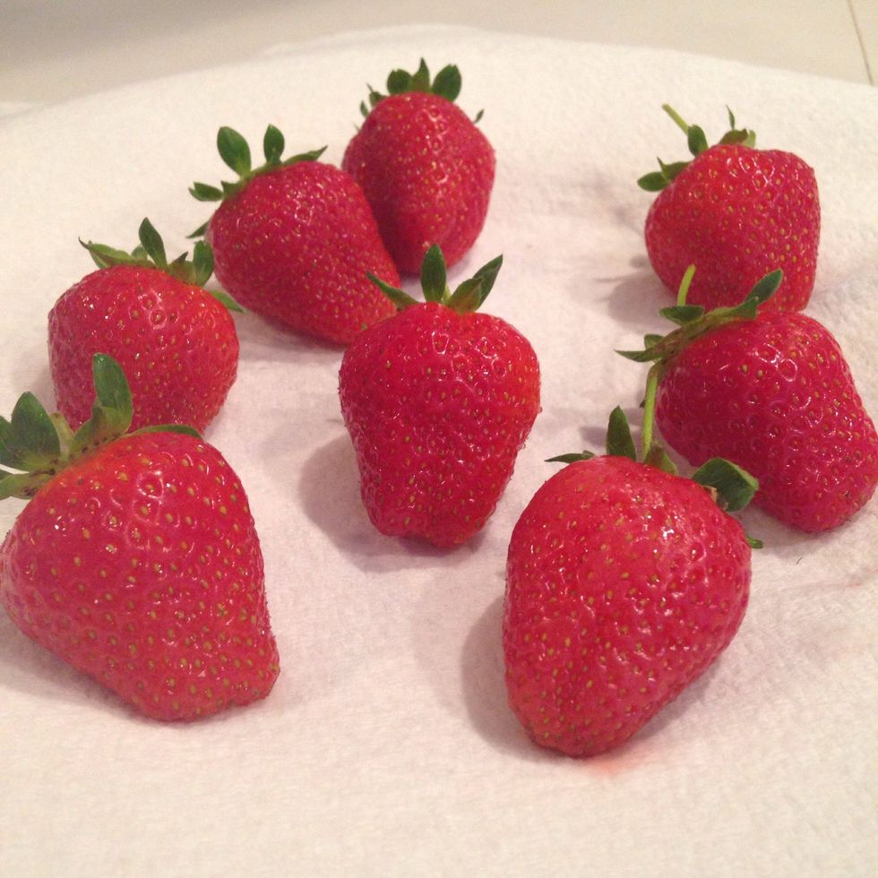 Place a paper towel over a plate and place strawberries on paper towel.
