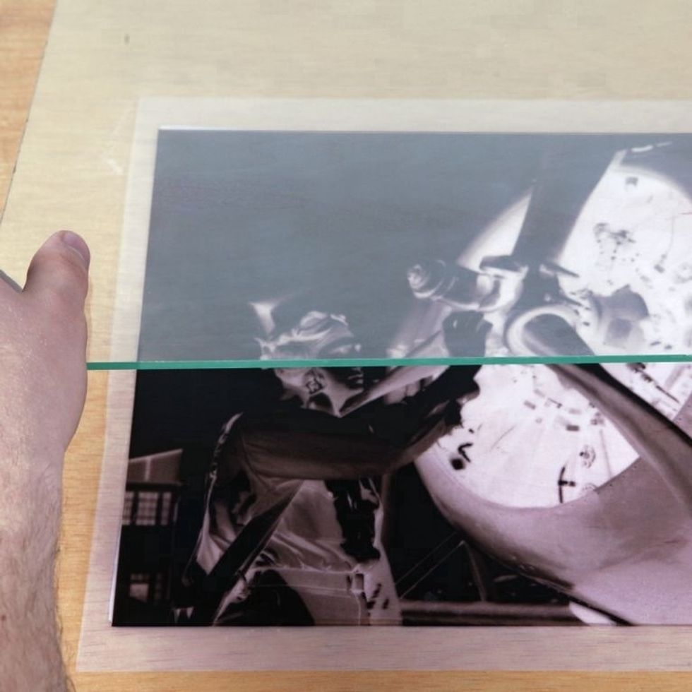 Place a piece of glass on top of wood & negative. This will hold the negative down during exposure and yield the sharpest prints. Note: Glass blocks some UV rays so exposure time may increase.