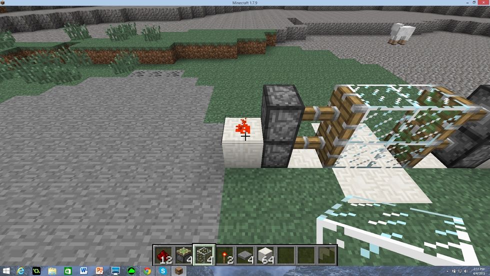 Place a piece of red stone on top of this block as shown in the picture. Do this on both sides.
