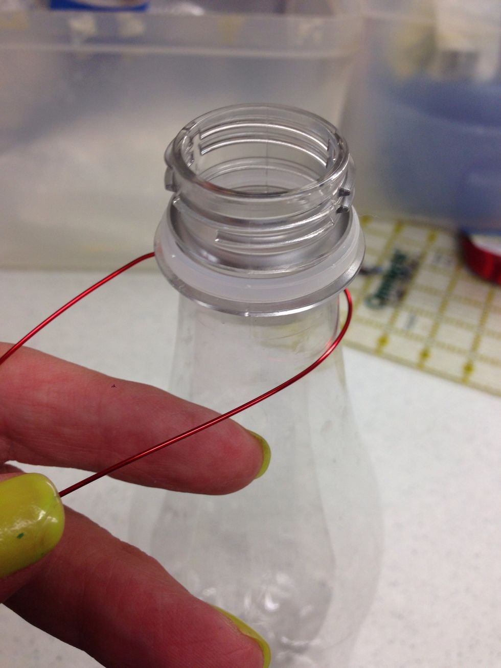 Place a piece of wire around the bottle.