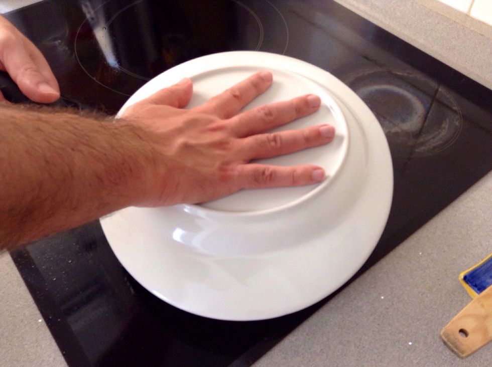 Place a plate over the pan and invert it so the omelette flips on to the plate.