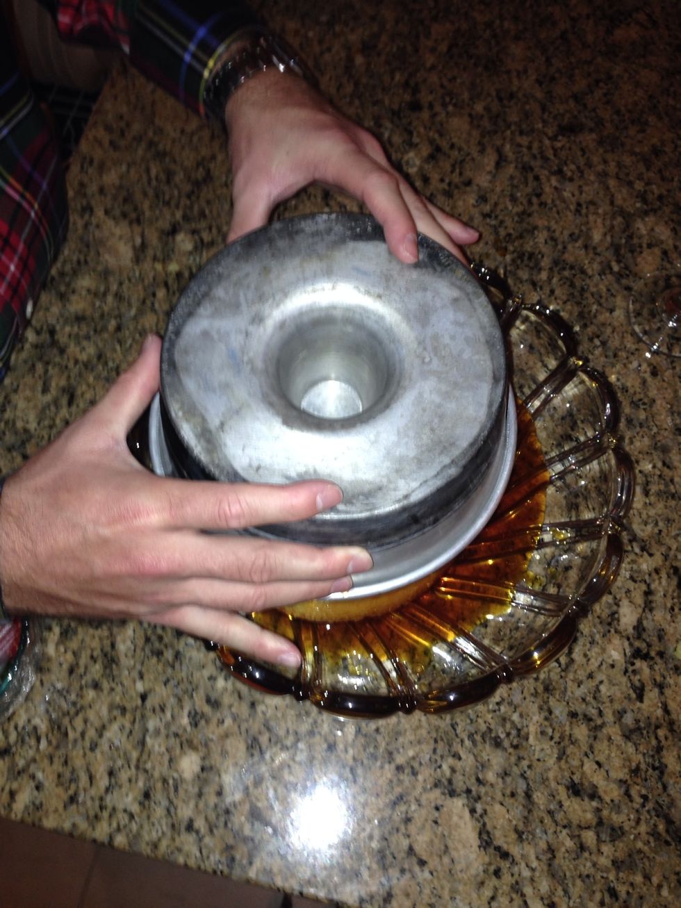 Place a plate/serving dish on top of the bundt form pan and QUICKLY flip upside down.