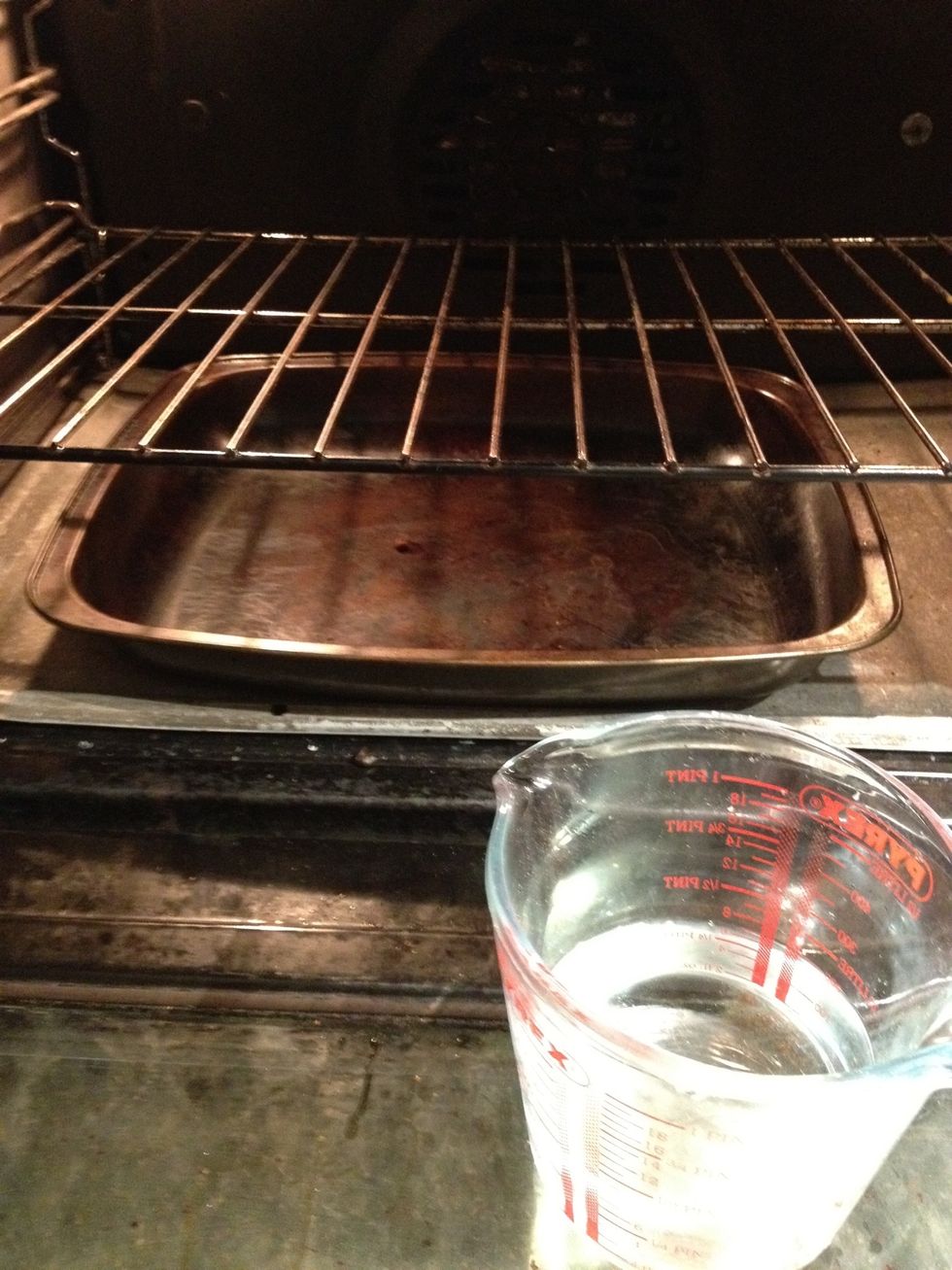Place a roasting tin into the oven and heat it to 230 degrees centigrade. Measure out 250ml water to pour it into the hot tin as you place the bread into the oven.
