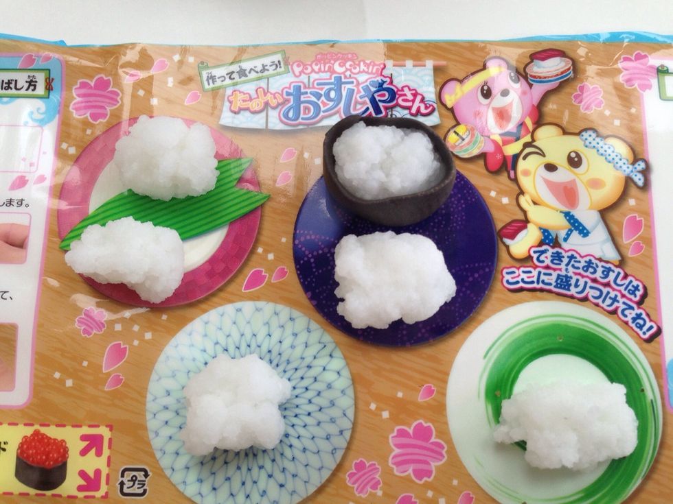 Place a Roll of Rice on Each Plate of your placemat--Roll One Roll of Rice in the Nori Seaweed