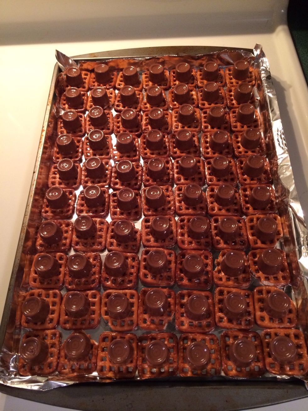 Place a Rolo on each pretzel, this sheet took 9 rolls of Rolos. You could buy them in a bag but I'm not patient enough to unwrap every candy for a batch this size.