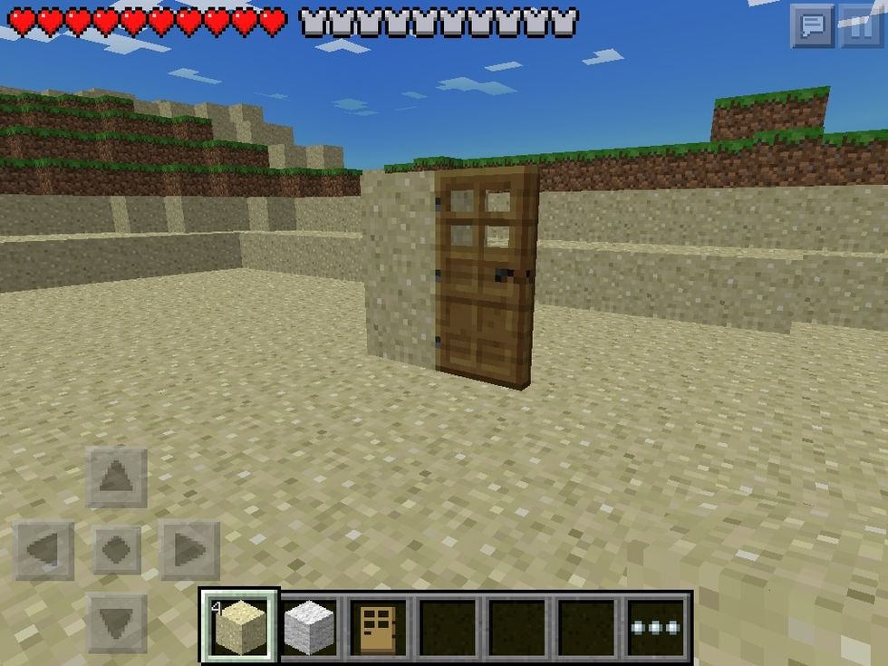 Place a sand wall 2 blocks tall and a door beside it Make sure the the hinges are facing toward the wall of sand