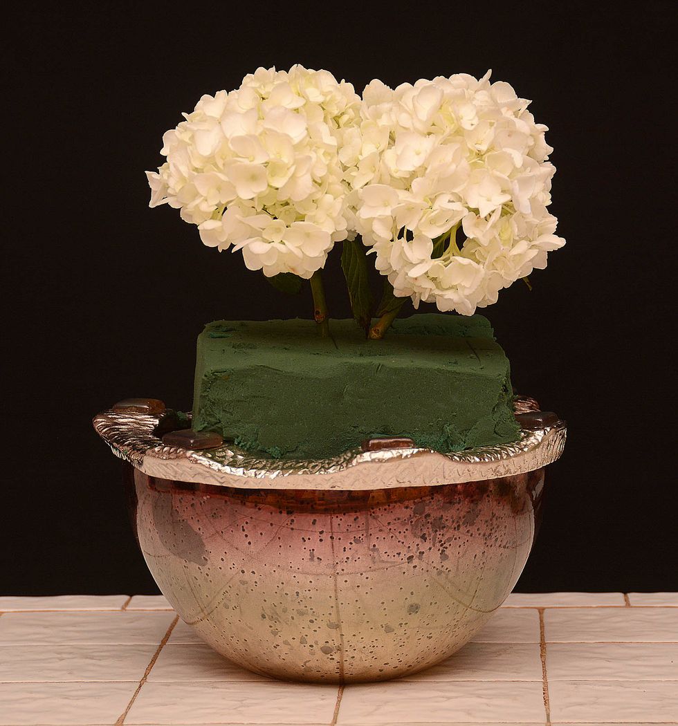 Place a second hydrangea next to the first. These will establish the height of this arrangement.