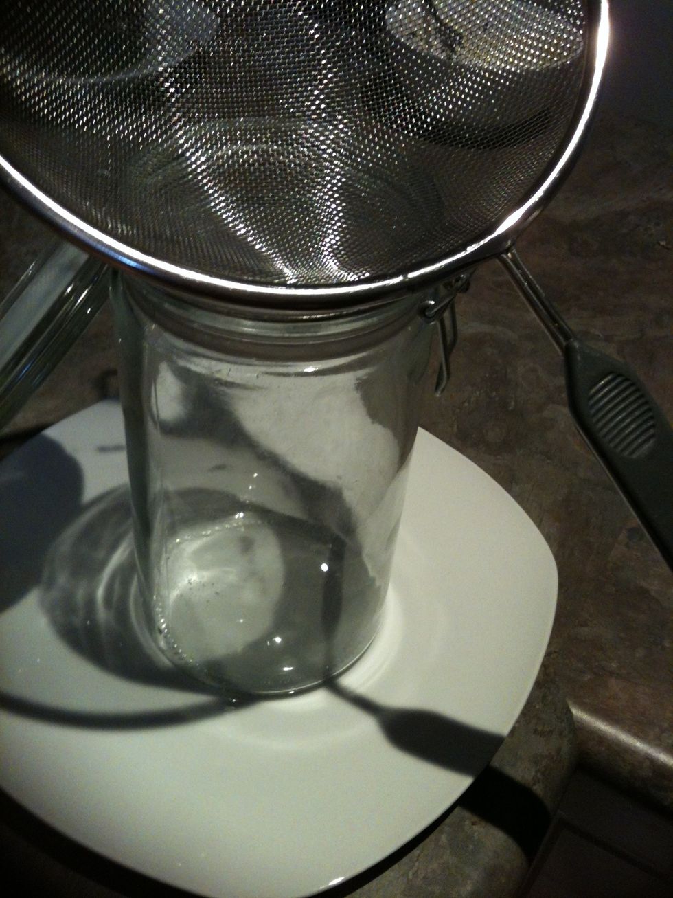 Place a seive over the glass jar.