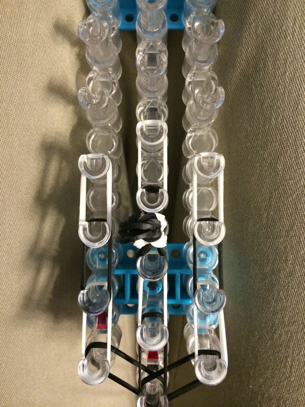 Place a set of 3 white bands on the next row.