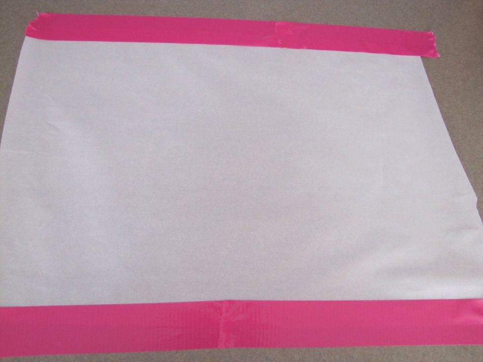 Place a sheet of parchment paper down on the counter. Tape down the edges so that it will stay put when you roll out the dough later (this is especially helpful if you're baking alone!)