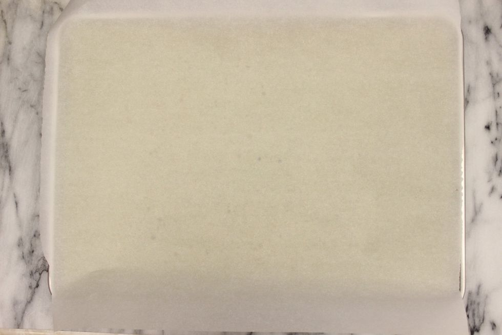 Place a sheet of parchment paper on top of the cake.