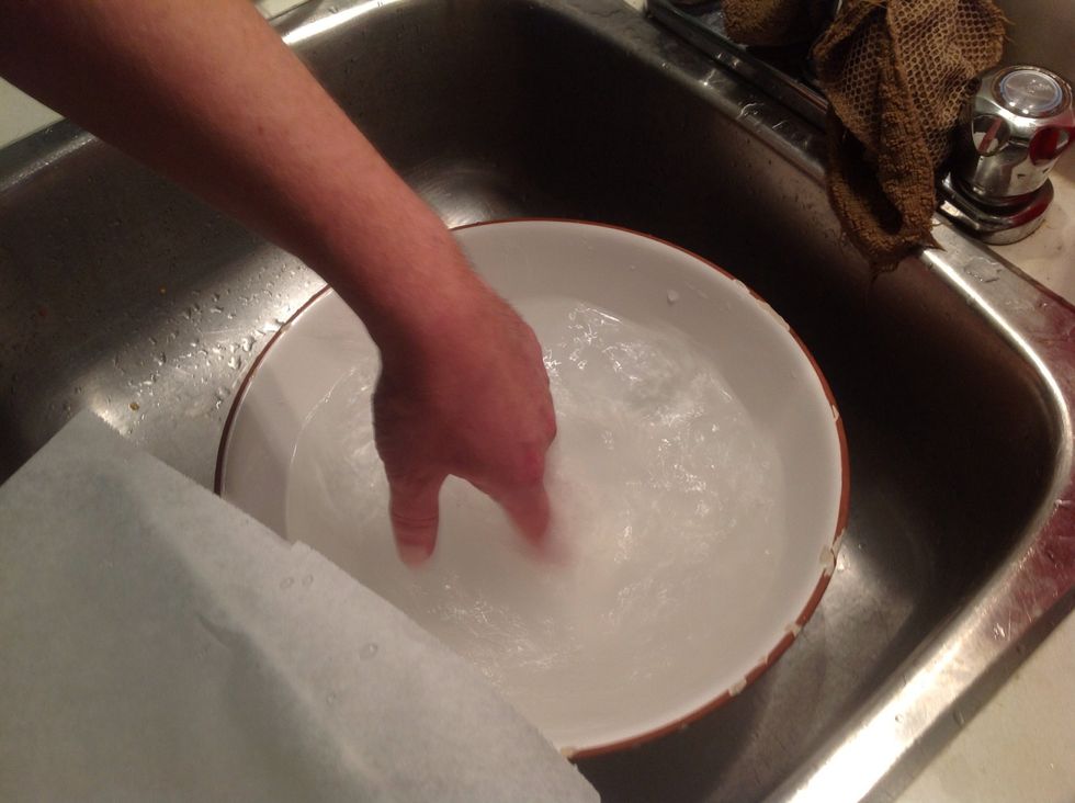 Place a single rice paper disk in a bowl of warm/hot water and spin it around until it becomes loose and sloppy.