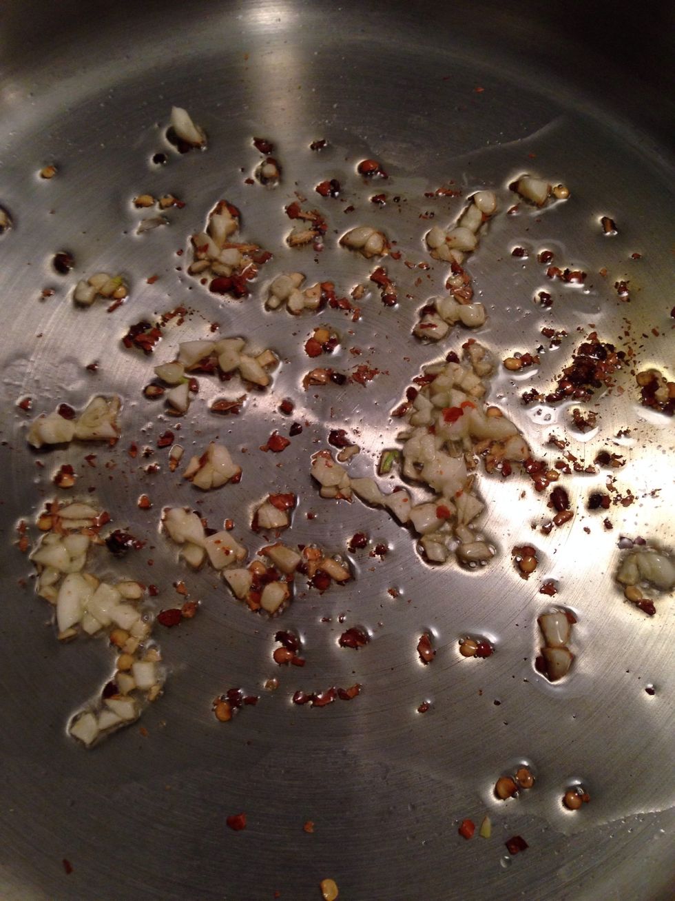 Place a skillet over medium heat & add the olive oil. Once it heats add garlic & red pepper flakes. Let it cook for about 30 seconds.