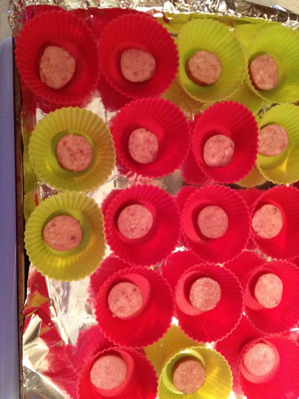 place a slice of sausage on each muffin cup... you can use cooked chicken or any filling you want!