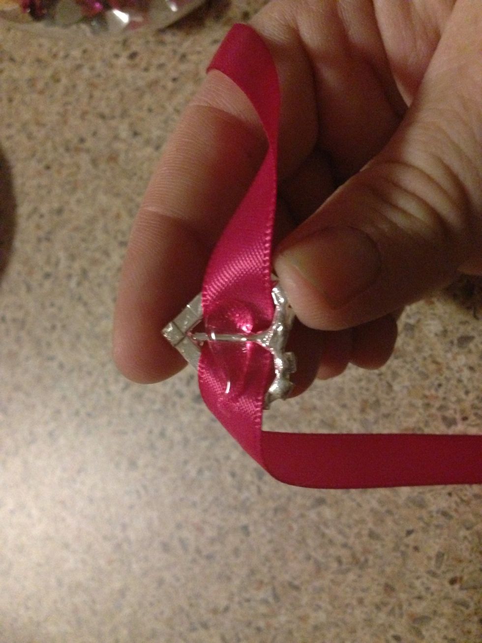 Place a small dab of hot glue on the underside of your heart gem.